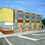 Thumbnail: A painting of an ugly building transformed by a faux mosaic palace mural, very colorful.