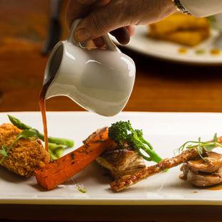 Chef-prepared meal at Oscar’s Brasserie at Rossett Hall Hotel with fresh ingredient and modern restaurant presentation.