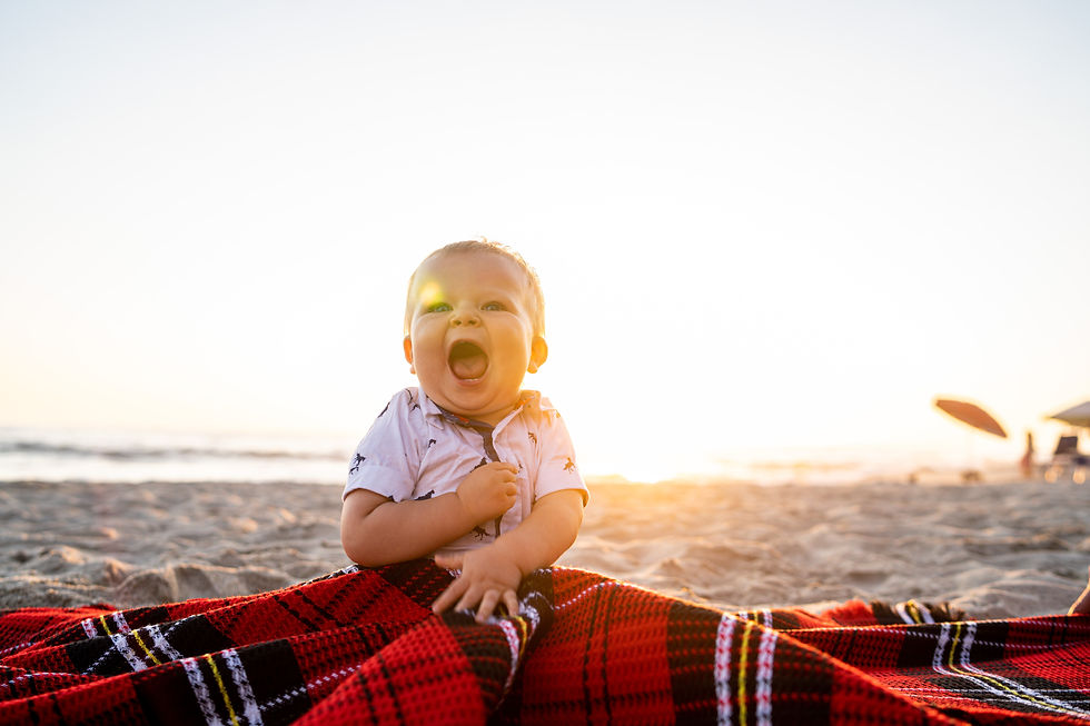 A baby holding colourful blanket