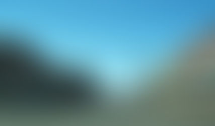 Downtown Reedsburg, WI Street Intersection with red stoplight and 2-story buildings lining both sides.