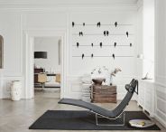 PK24, designed by Danish Poul Kjærholm in 1965. Introduced with black leather in 2007 for the Autumn/Winter Collection 2007. Also Available in wicker with headrest in leather. Base is stainless steel.