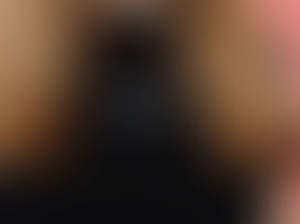 A close-up of a person wearing a black shirt printed with the bold phrase “OK BUT NO.”