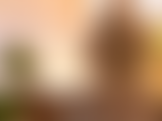 A tired but determined supervisor sitting alone at a desk after hours, reflecting with a cup of coffee