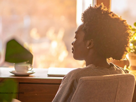 A tired but determined supervisor sitting alone at a desk after hours, reflecting with a cup of coffee