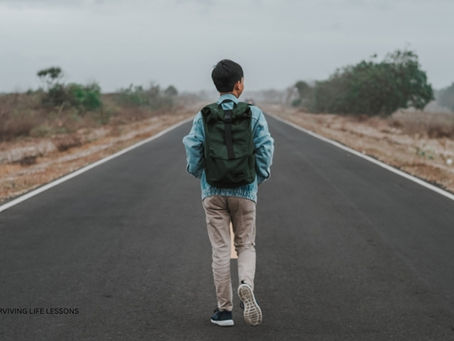 Walking forward on an open road under a cloudy sky.