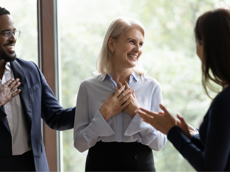 Woman smiling softly while receiving a compliment, symbolizing self-acceptance and confidence