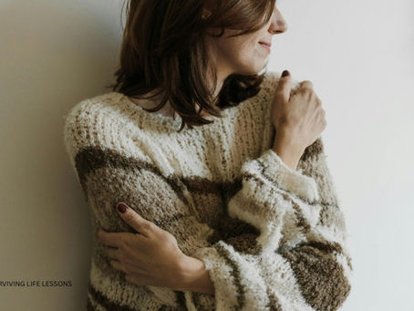 A woman hugs herself gently, symbolizing self-compassion and the journey of rebuilding trust after disappointment.