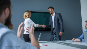 Two professionals shake hands in a meeting room, marking teamwork, trust, and new opportunities.