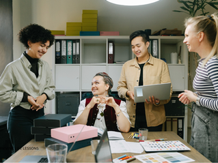 Supervisor talking with team members in a friendly office setting