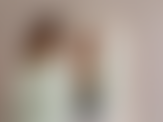 Woman looking into mirror with calm expression, symbolizing self-acceptance and positive self-talk