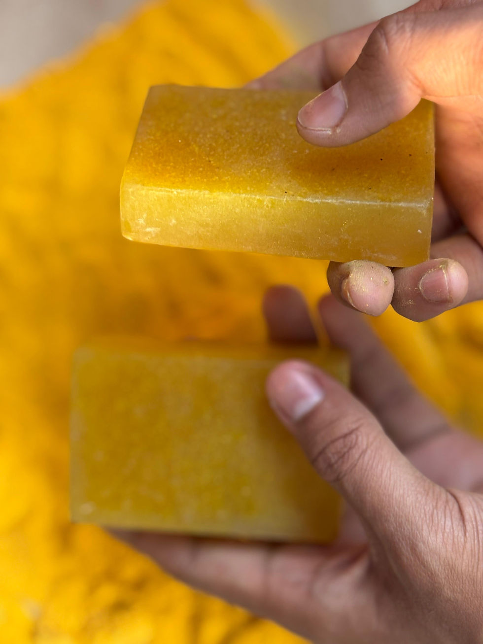 Thumbnail: two pieces of orange handmade soap showing its size