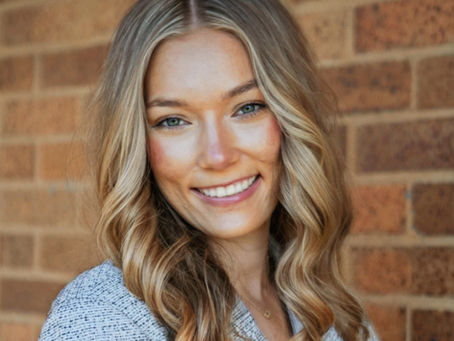 Portrait of Olivia Frichtl, LSW, a compassionate teen and young adult therapist based in Champaign, IL, smiling in a warm and welcoming setting.