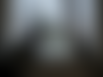 A person wearing a hoodie and beanie leans on a windowsill, staring out a rainy window with a cat beside them. Outside, trees bend in the wind, evoking a quiet, melancholic mood.