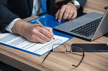 Writing in a file next to a laptop
