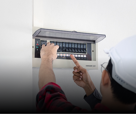Technician adjusting an electrical panel