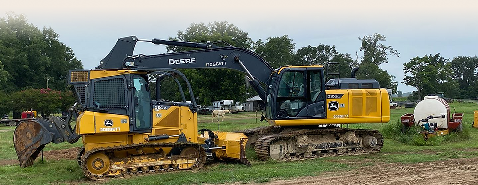 Two John Deere excavators parked outdoors