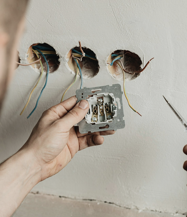 Worker installing electrical outlet