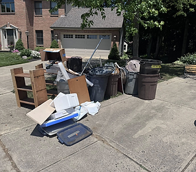 Pile of discarded household junk on a driveway