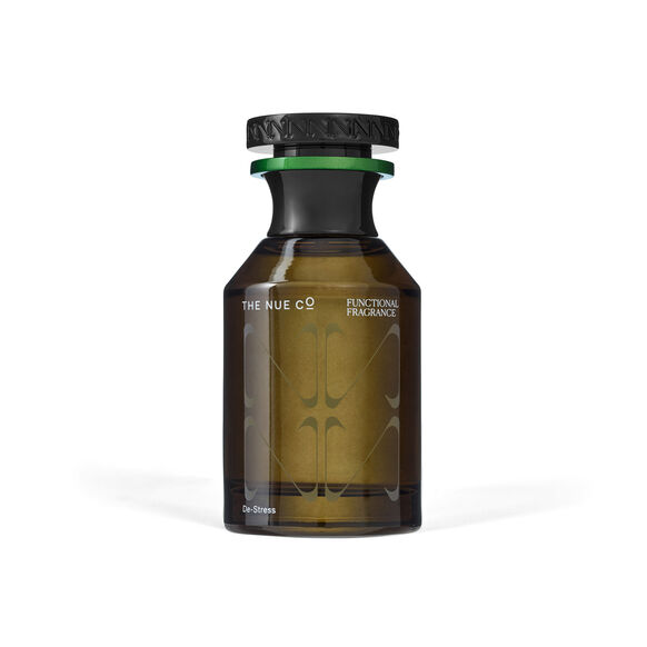 Brown glass bottle labeled "The Nue Co Functional Fragrance." Black cap, green band. Minimalist design, white background.