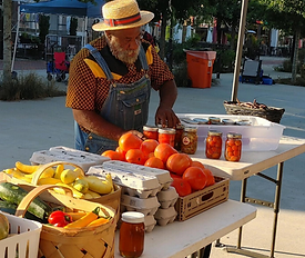 A vendor preparing his table for the RVAs Black Farmers Market