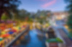 River walk in San Antonio city downtown skyline cityscape of Texas USA at sunset.jpg