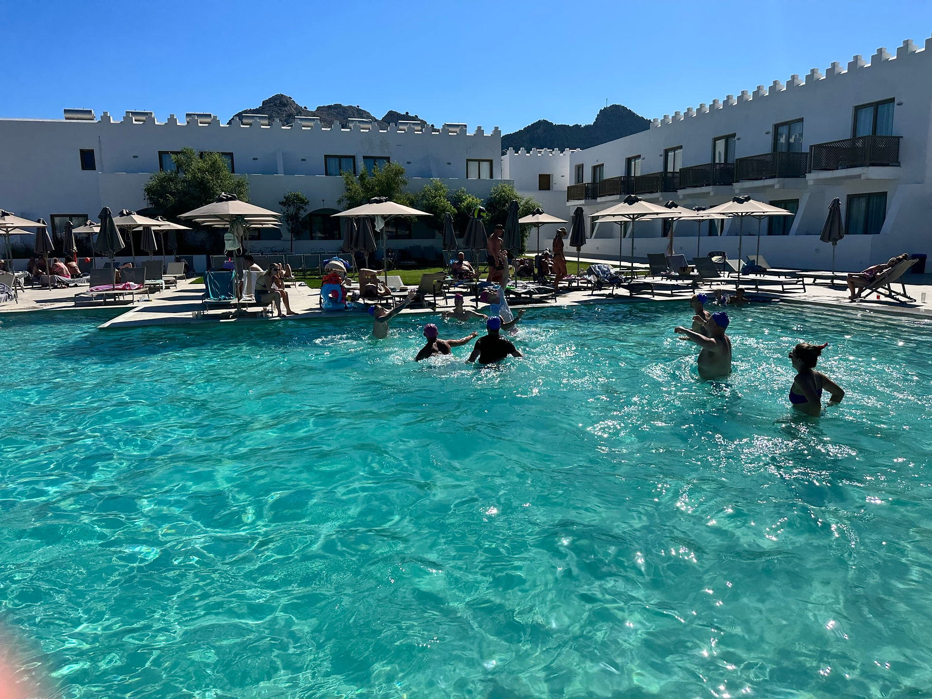 Pool people playing volleyball