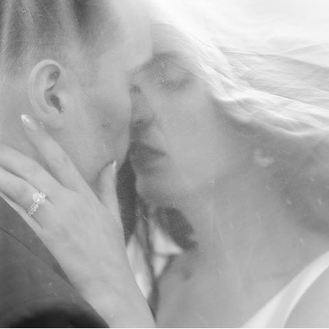 Black and White photo of couple under a veil 