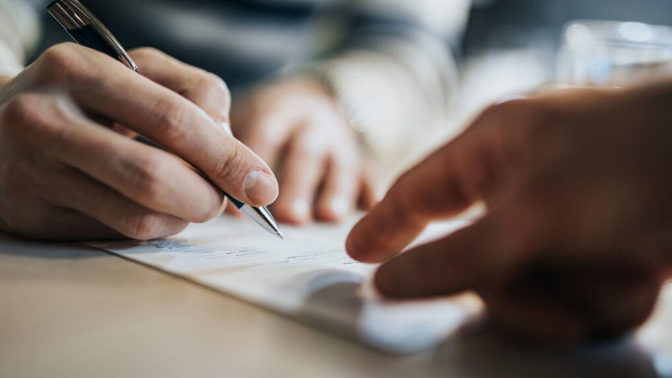 a hand pointing at a paper