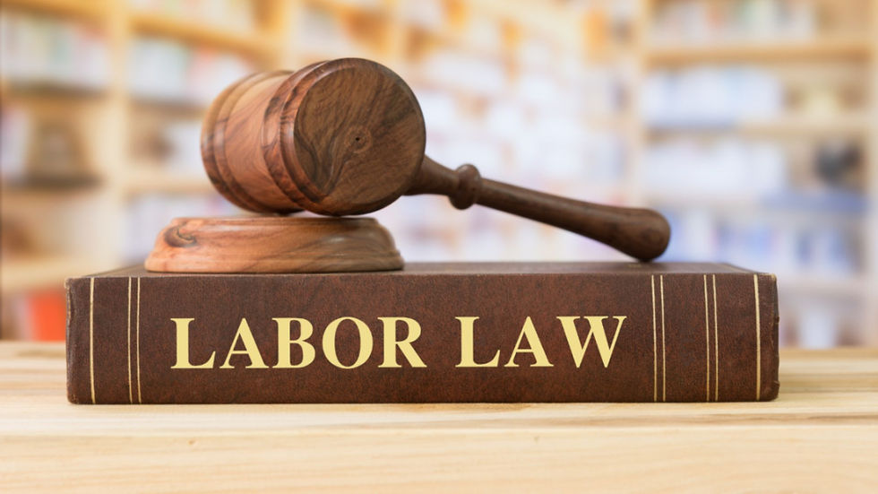 Gavel resting on a "Labor Law" book on a wooden table.