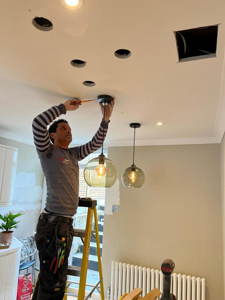 Electrician installing a light.