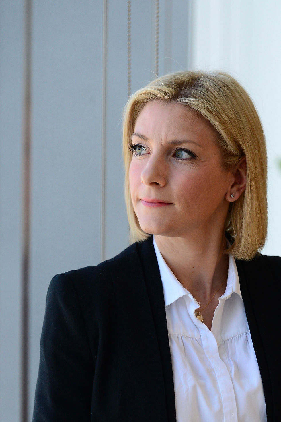 Professional woman looking thoughtfully out of the window