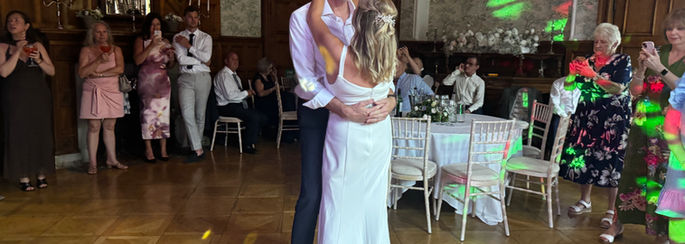 Hollie Marie with bride and groom as they share their first dance wedding reception at Pendly manor, Tring.