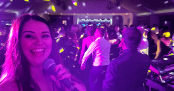 Hollie Marie Performing live at a corporate event in corby. the dancefloor is full of pleople having a brilliant time. lots od enery and disco lights.