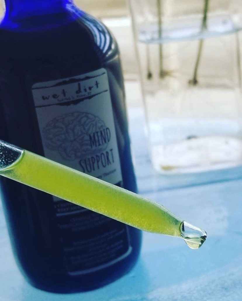 Mind support tincture in a glass droppper. Mineral content visible