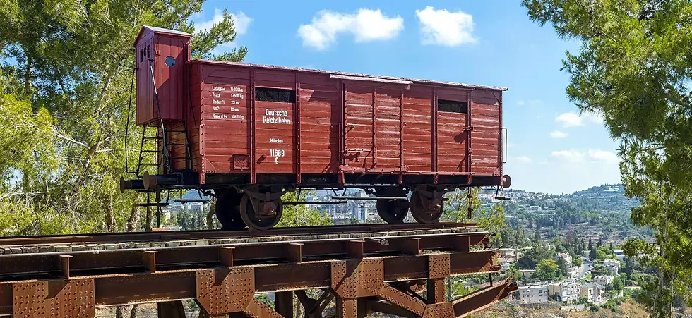 A red railcar once used by the Nazis stands at the end of rail tracks, suspended over a cliff in Jerusalem.