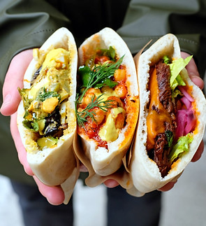 Three pita wraps with colorful fillings from a culinary tour in Tel Aviv