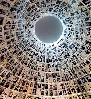 The Hall of Names — a brightly lit, spiral ceiling covered in photos of victims murdered in the Holocaust — inside the Holocaust History Museum of Jerusalem's Yad Vasem