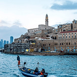 A boat departs from the harbor of Old Jaffa in Israel.