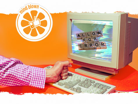 fist on keyboard of a 90s desktop computer with screen spelling in Scrabble letters "ALLOW FOR ERROR"