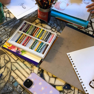 people using rainbow colored pencils