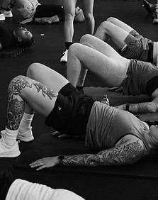 Two women performing bridge exercises on yoga mats, demonstrating the focus on mobility, stability, and movement sessions for all ages.