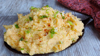 Golden Potatoes with Crema, Green Onion and sprinkled with Guajillo Chili Powder