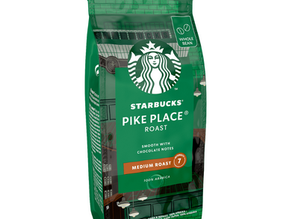 Green Starbucks Pike Place Roast coffee bag labeled "Medium Roast" with chocolate notes. Features the iconic logo.
