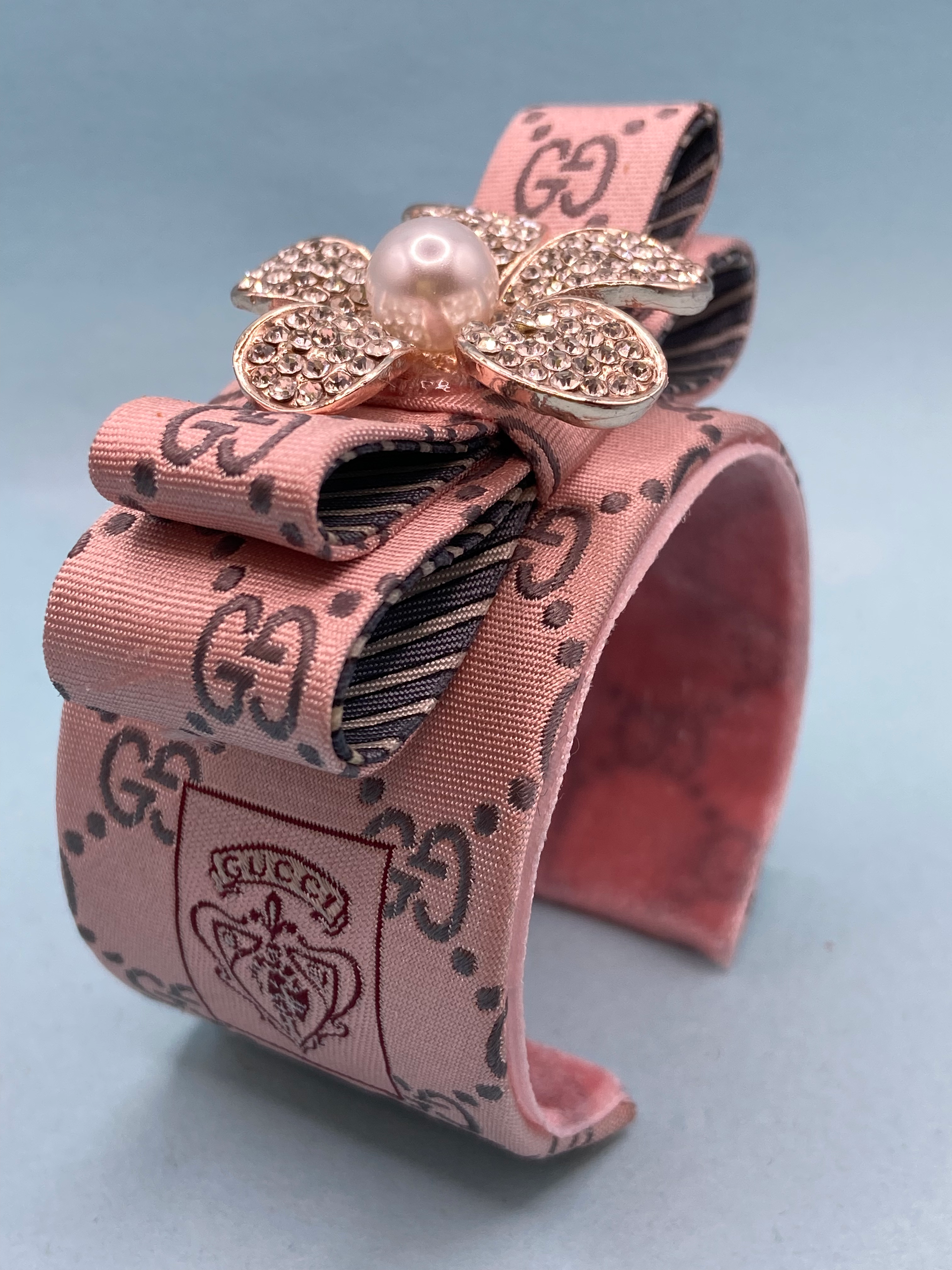 Pink Gucci logo weave cuff with pearl daisy made from a vintage silk Gucci tie
