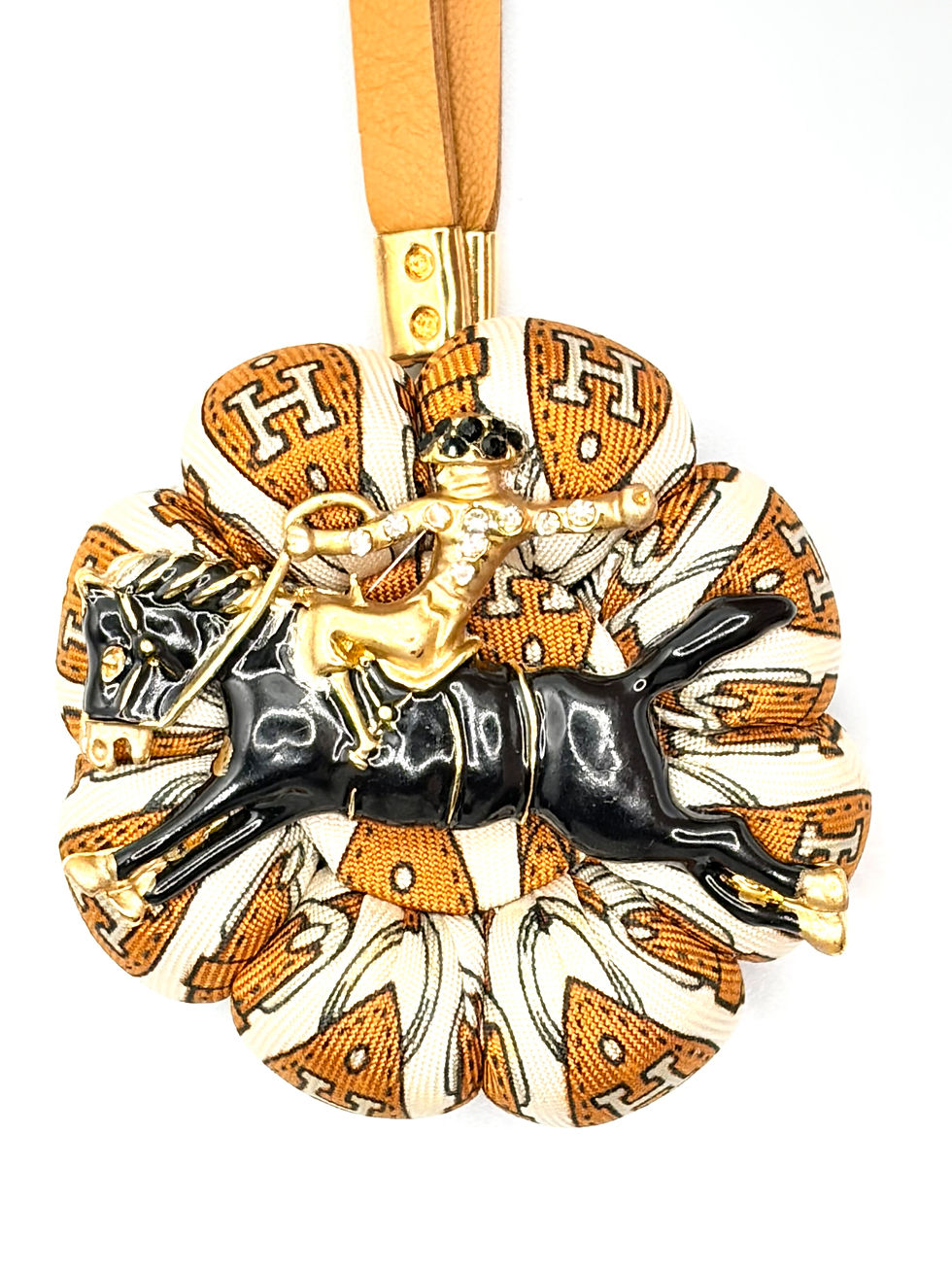 Thumbnail: Tan strap print rodeo rider bag charm made from a vintage Hermes silk tie