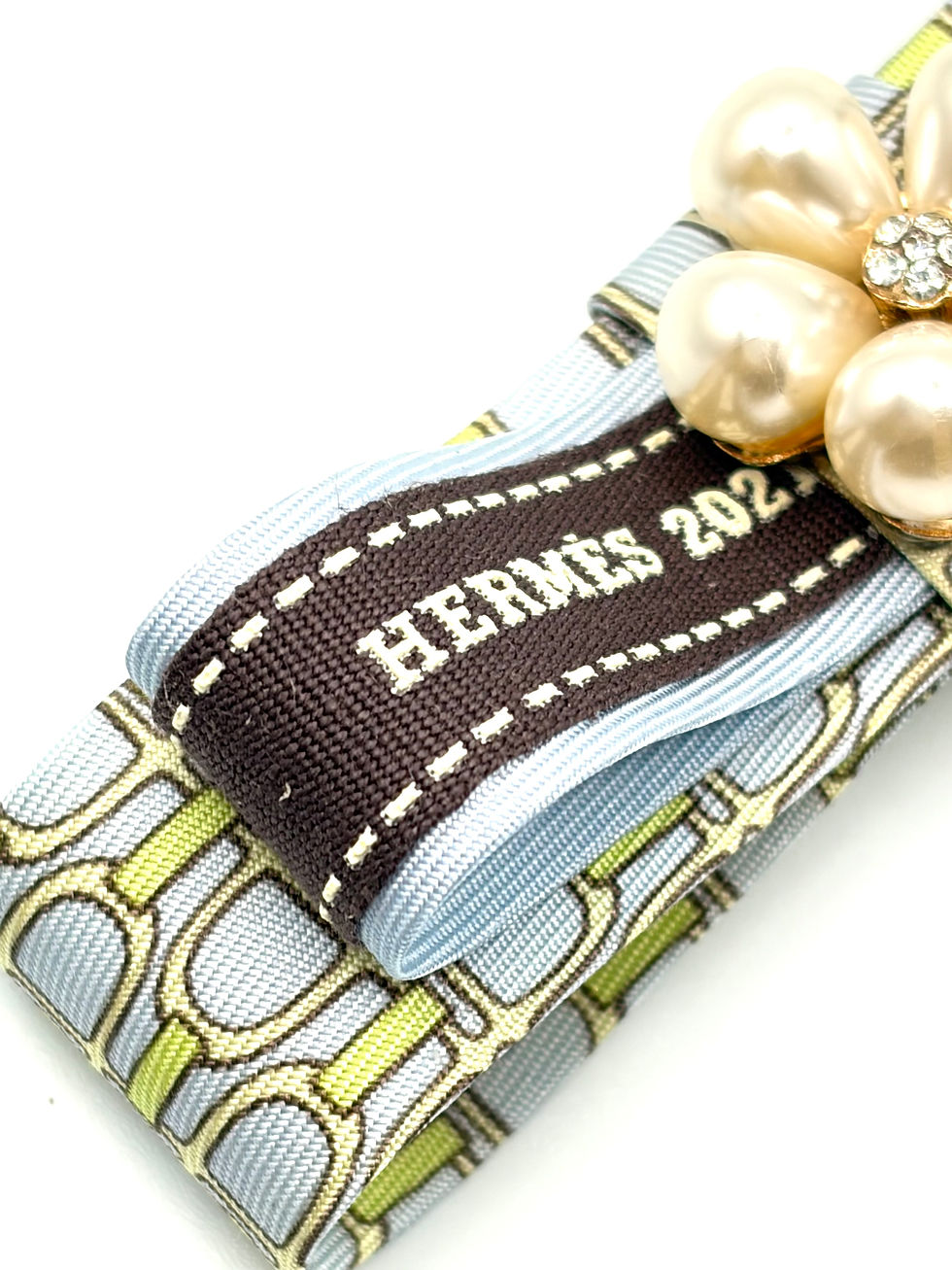 Thumbnail: Aqua stirrup print bow brooch with ladybug made from a vintage silk Gucci tie 