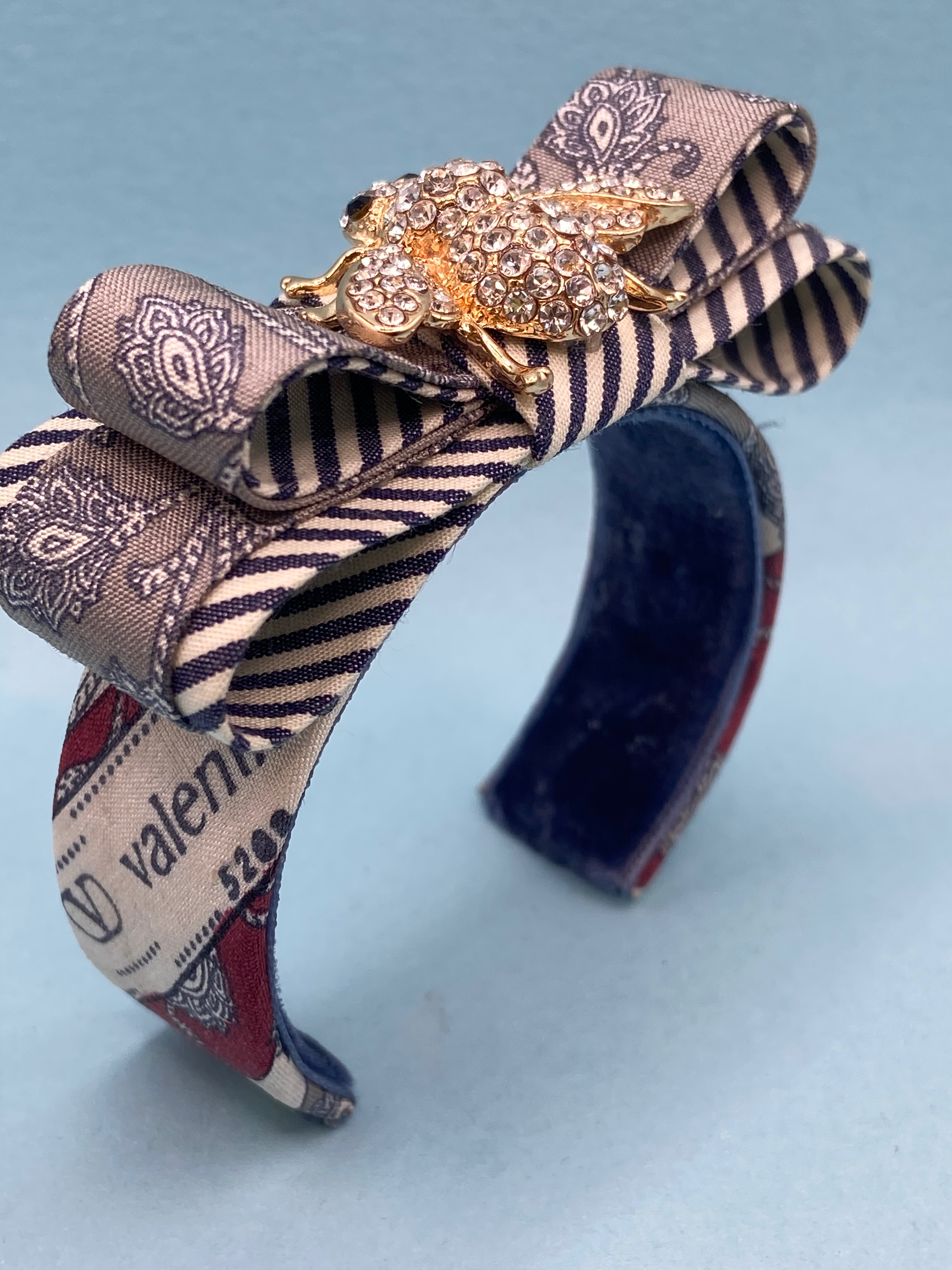 Grey & white paisley print cuff with bee made from a vintage silk Valentino tie