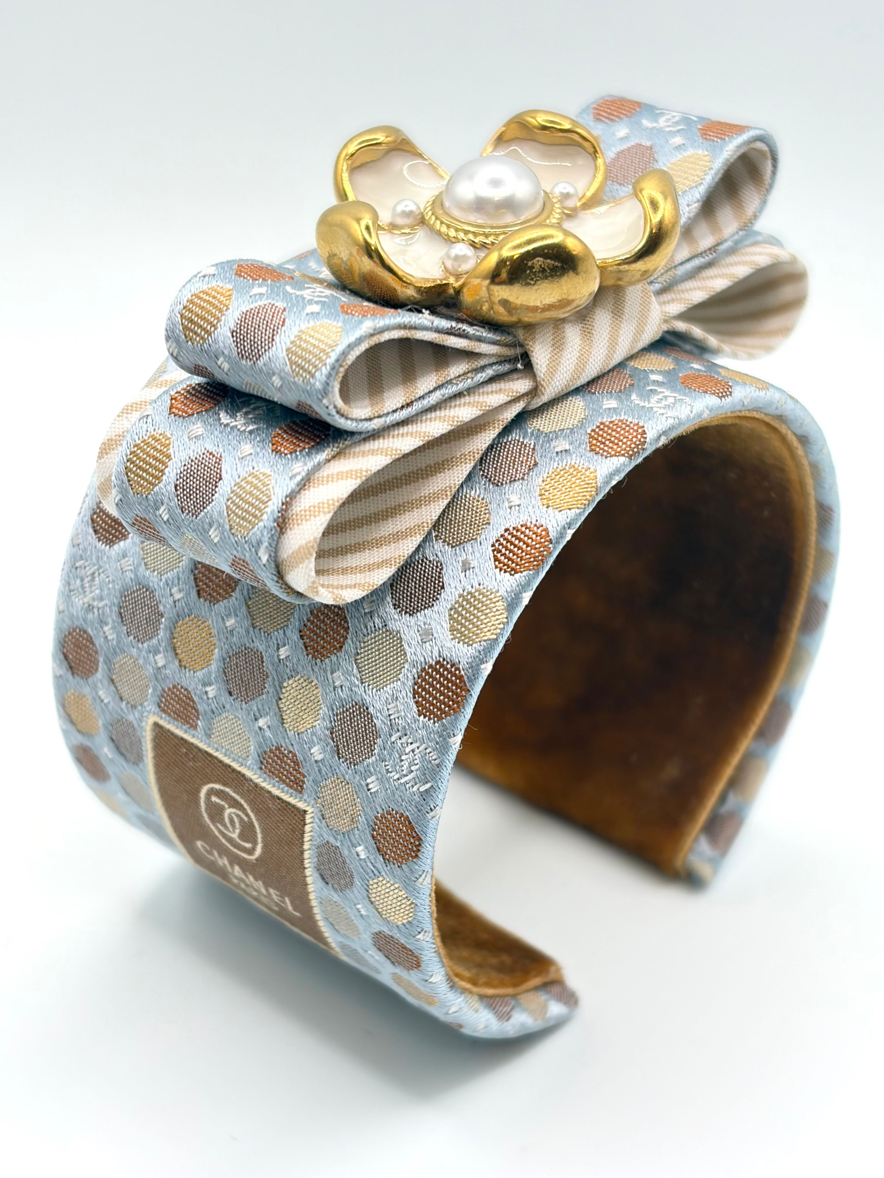 Tan & powder blue dot print cuff with flower made from a vintage Chanel silk tie