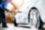 Car Wash detail. Vehicle During Washing Process. Manual wheel washing in outside using bru