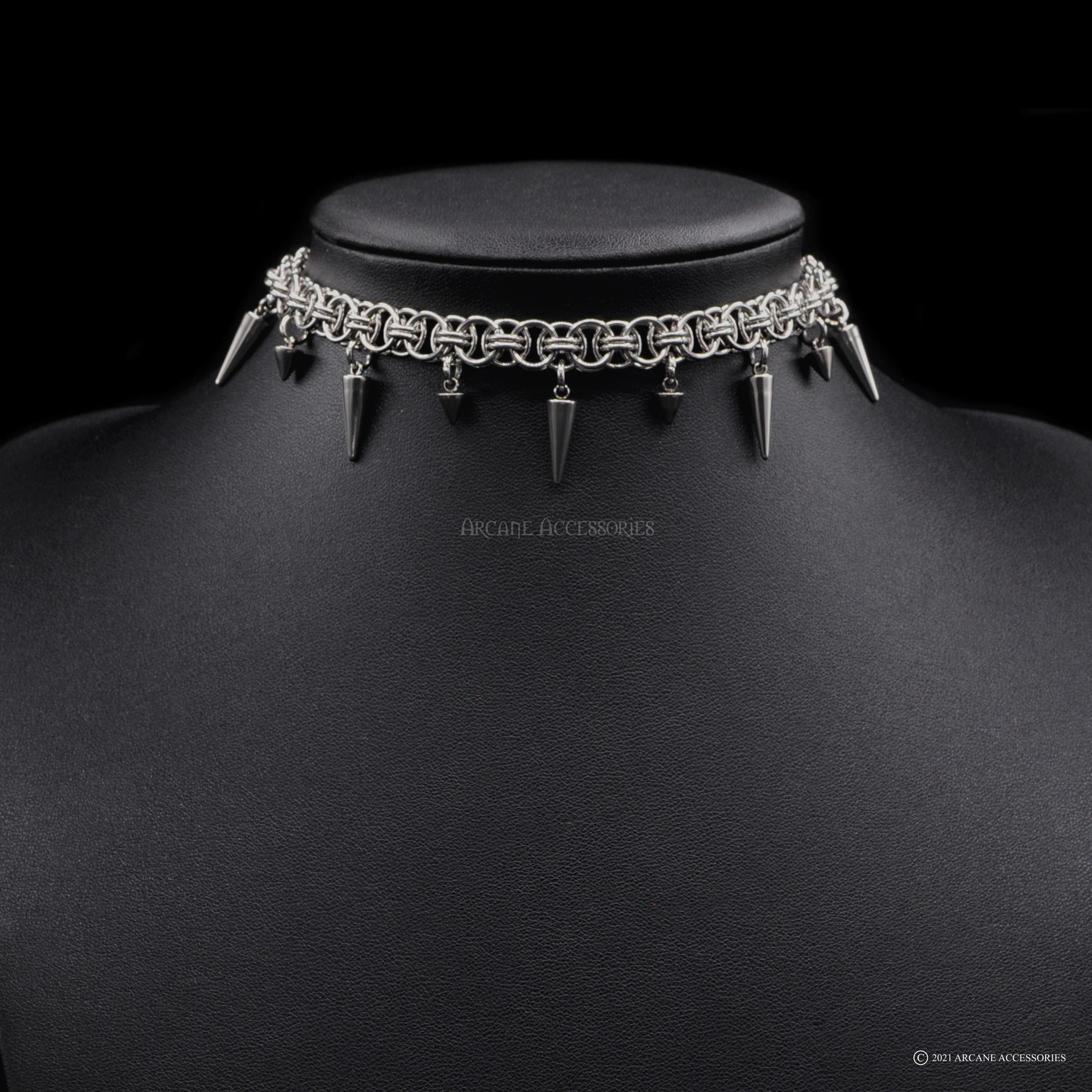 This elegant choker combines simplicity with an edge, featuring two sizes of spikes.